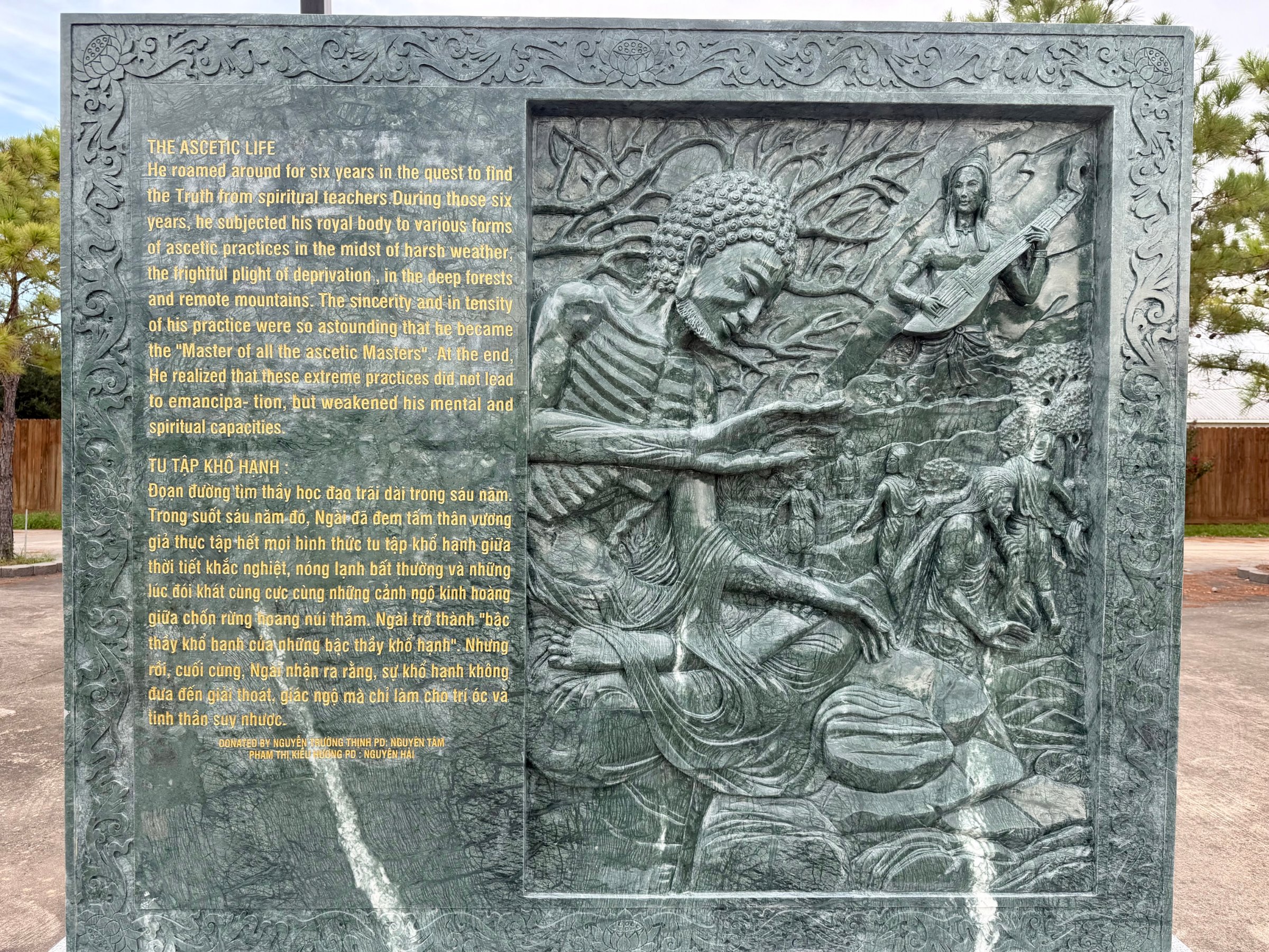 Carved stone panel 6 of the life of the Buddha: relief beside its English and Vietnamese text