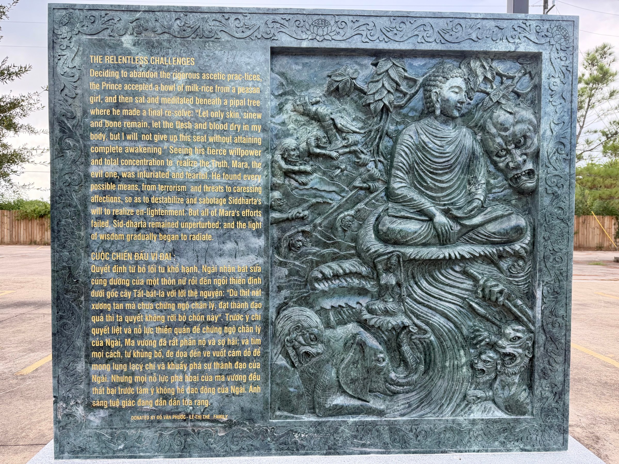 Carved stone panel 7 of the life of the Buddha: relief beside its English and Vietnamese text