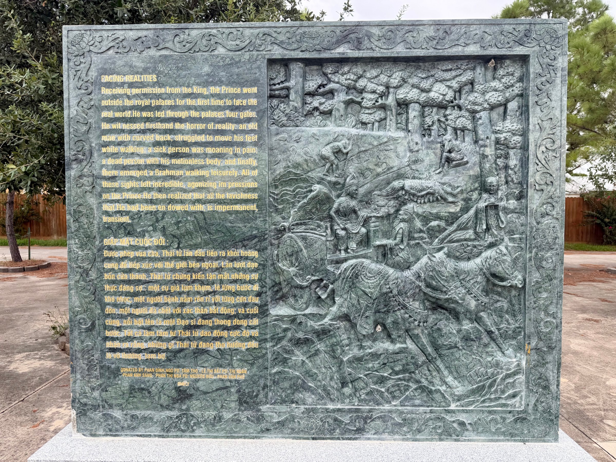 Carved stone panel 4 of the life of the Buddha: relief beside its English and Vietnamese text