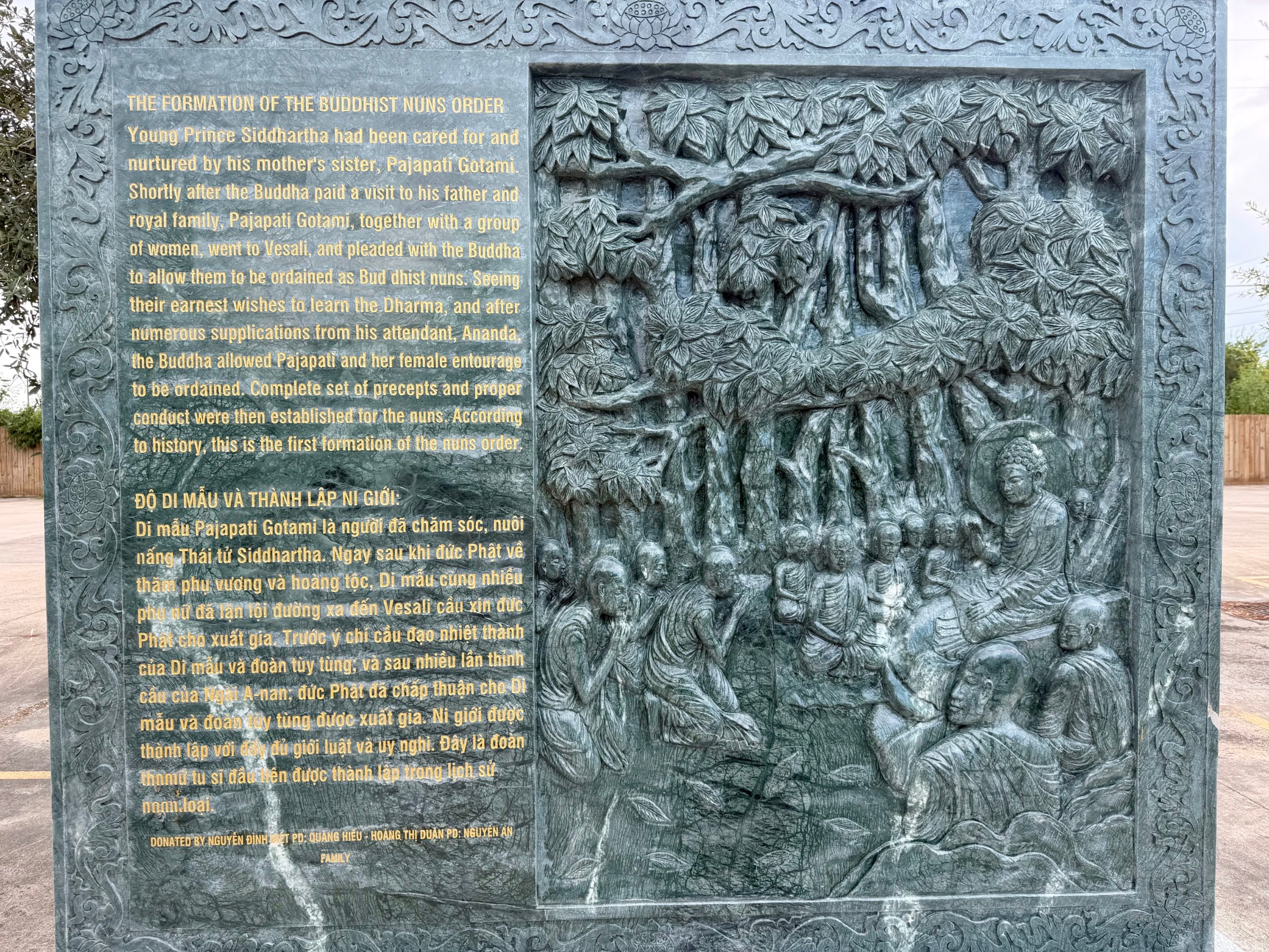 Carved stone panel 10 of the life of the Buddha: relief beside its English and Vietnamese text