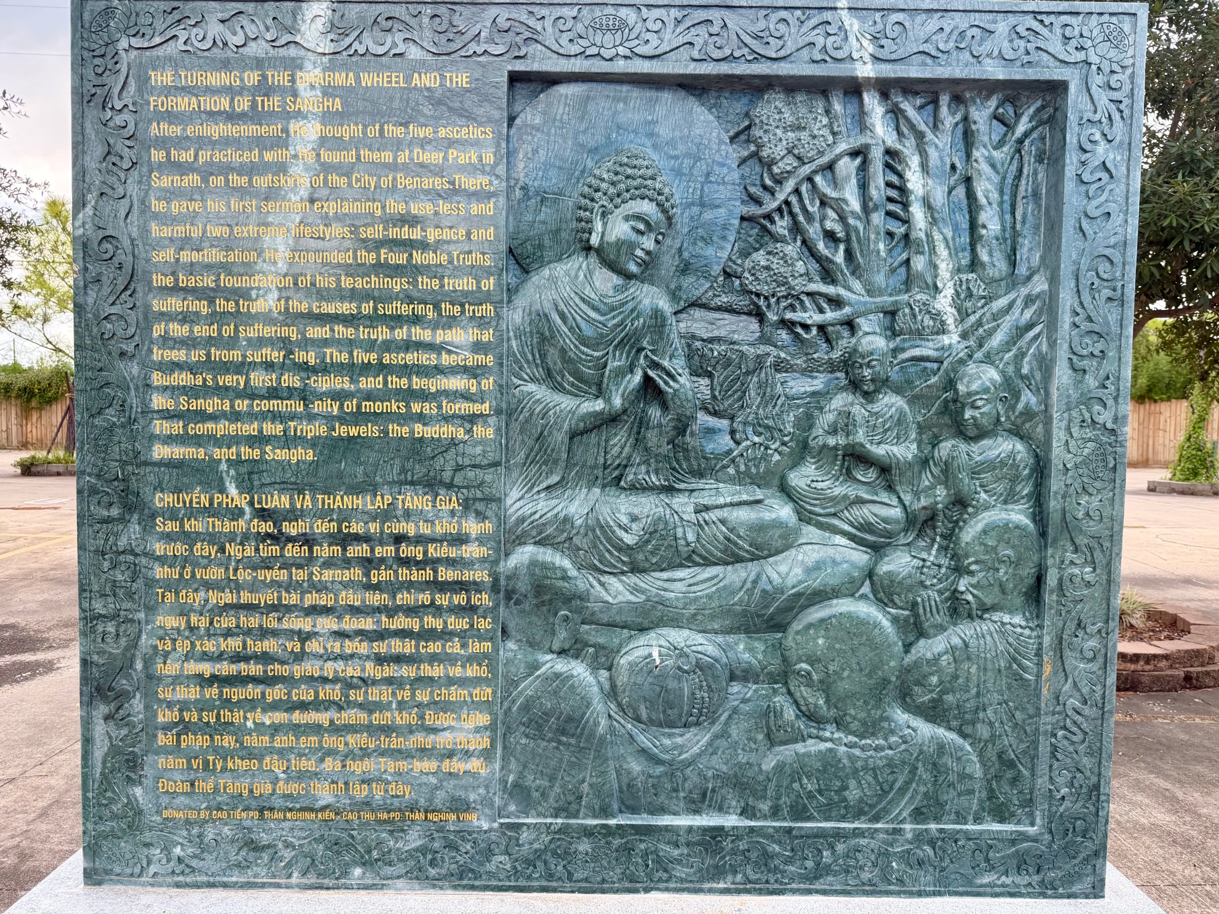 Carved stone panel 9 of the life of the Buddha: relief beside its English and Vietnamese text